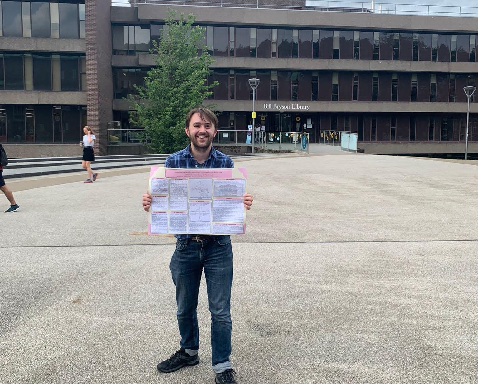 Peter Kissack holding his masters dissertation poster
